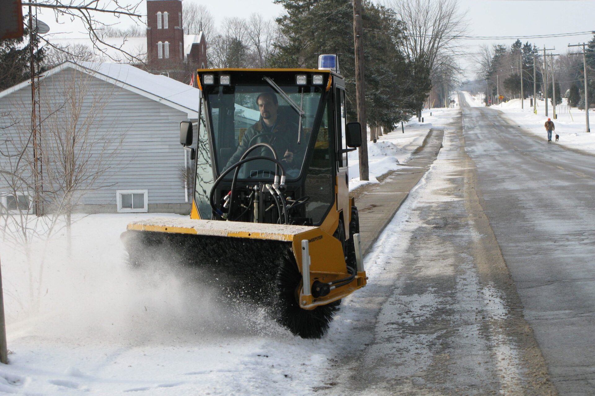 trackless vehicles mt6 tractor with power angle sweeper attachment sweeping snow