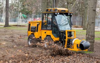 trackless vehicles buffalo turbine debris blower attachment on sidewalk municipal tractor blowing leaves side view