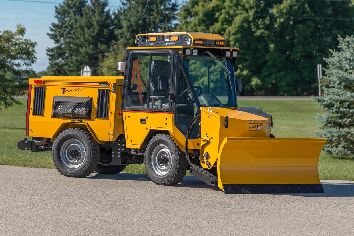 trackless vehicles front-mount spreader and plow attachment on sidewalk tractor side view