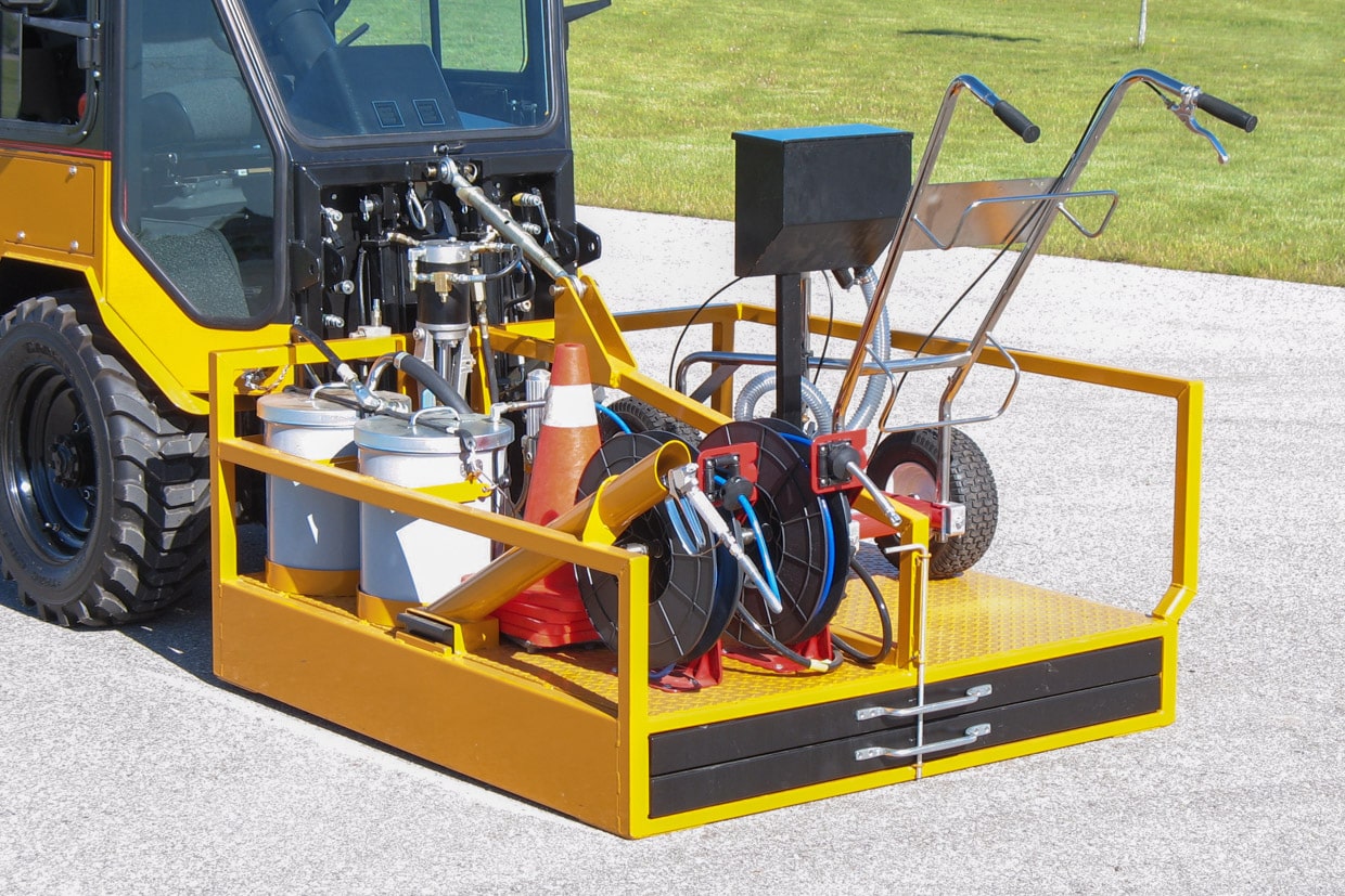 trackless vehicles line and stencil painter attachment on sidewalk tractor front view