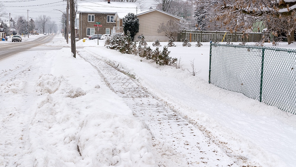 snow on ground after trackless vehicles 5-position folding v-plow attachment on sidewalk tractor