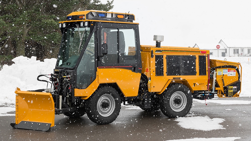 trackless vehicles 5-position folding v-plow attachment on sidewalk tractor in snow side view