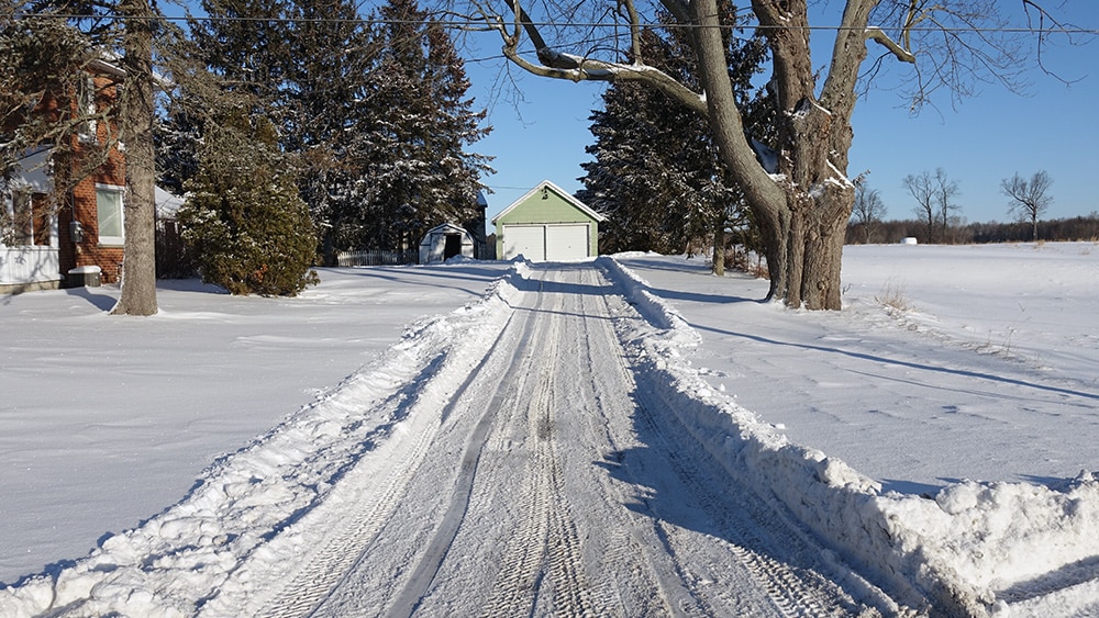 snow on ground after trackless vehicles 5-position folding v-plow attachment on sidewalk tractor