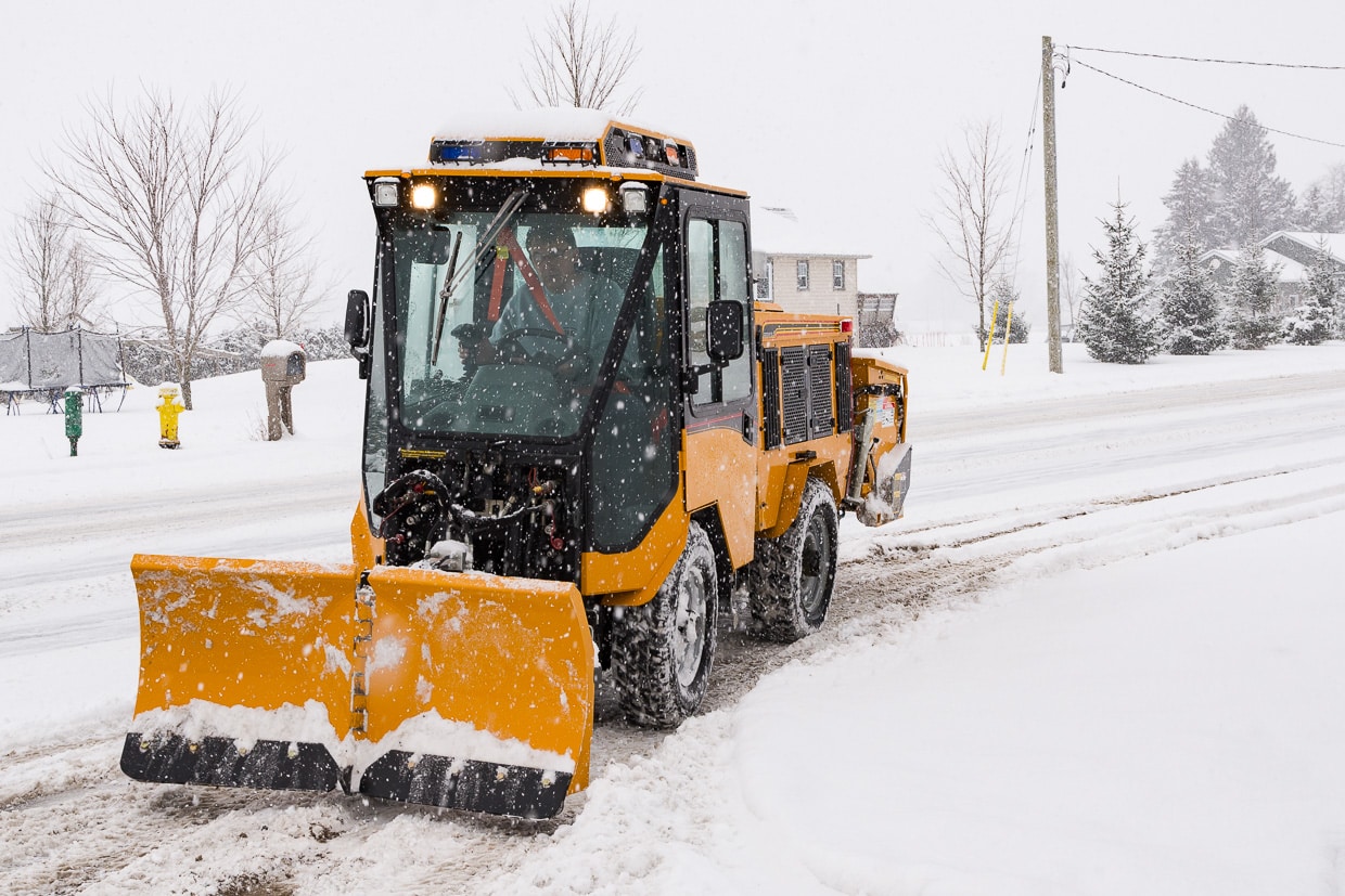 trackless vehicles 5-position folding v-plow attachment on sidewalk tractor in snow front view