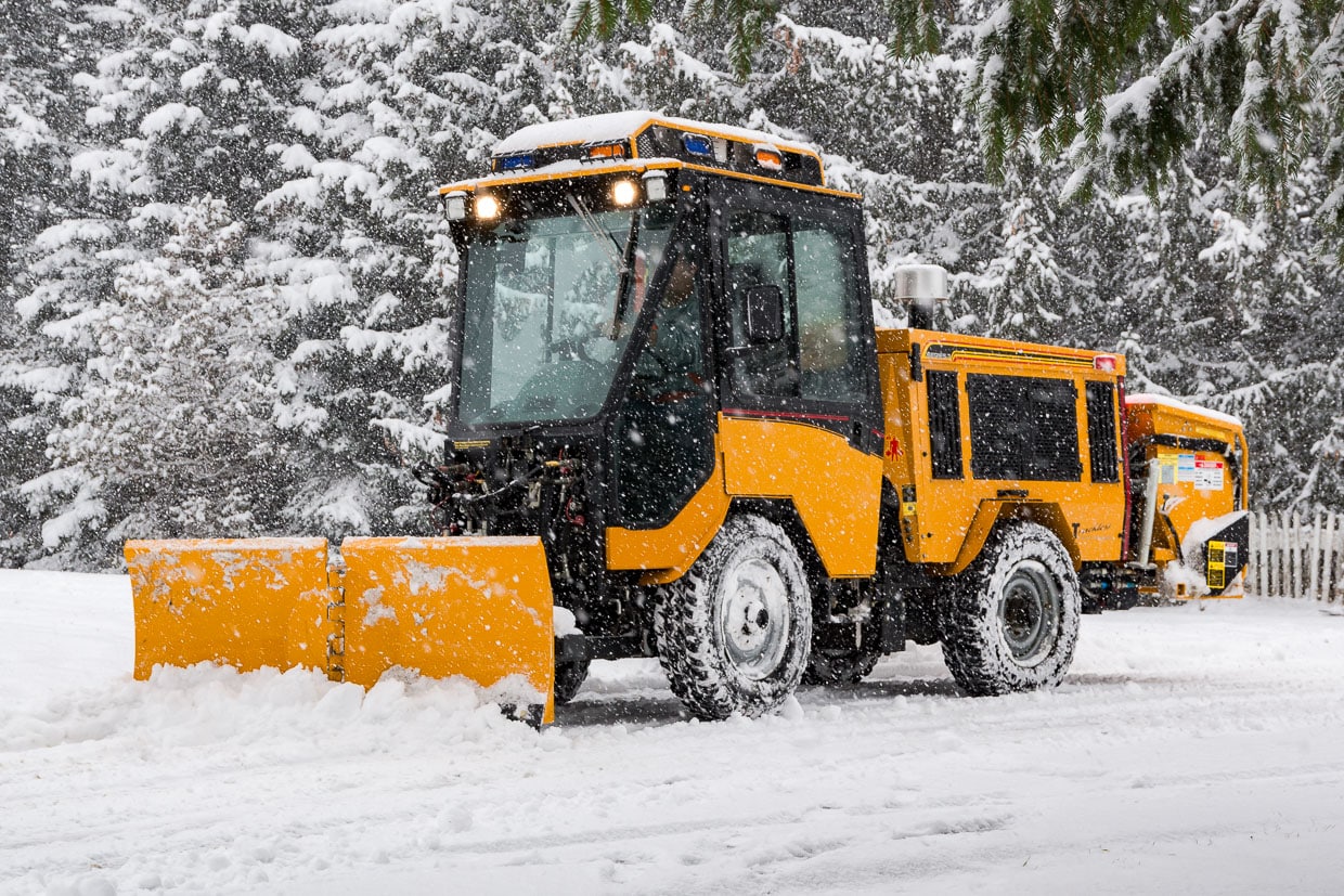 trackless vehicles 5-position folding v-plow attachment on sidewalk tractor in snow side view